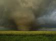 An F4 Category Tornado Travels Across A Field At Great Speed by Carsten Peter Limited Edition Print