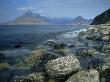 Rugged Coast Of Skye, Scotland, With The Cuillin Hills Across The Bay by Adam Burton Limited Edition Print