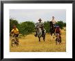 Mountain Bikers And Horse Riders At Mashatu Game Reserve, Botswana by Roger De La Harpe Limited Edition Print