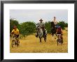 Mountain Bikers And Horse Riders At Mashatu Game Reserve, Botswana by Roger De La Harpe Limited Edition Print