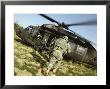 Us Army Soldiers Board A Uh-60 Black Hawk Helicopter by Stocktrek Images Limited Edition Print