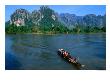 Longboat Crossing Nam Song From Limestone Formations With Honeycomb Caves, Vang Vieng, Laos by Kraig Lieb Limited Edition Print