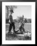 Two Boys Getting Water From A Pump At Rural School by Thomas D. Mcavoy Limited Edition Print