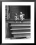 African American Boys At Top Of Stairs As Older Boy Is Drinking Soda And Younger One Reaches For It by Alfred Eisenstaedt Limited Edition Print