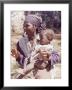 Haitian Woman Smoking A Pipe While Holding A Baby by Lynn Pelham Limited Edition Pricing Art Print