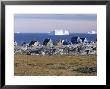 Painted Village Houses In Front Of Icebergs In Disko Bay, West Coast, Greenland by Anthony Waltham Limited Edition Pricing Art Print