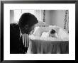 Sen. Jack Kennedy Admiring Baby Caroline As She Lies In Her Crib In Nursery At Georgetown Home by Ed Clark Limited Edition Print