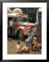 Man Seated With Two Young Boys In Front Of A Wildly Painted School Bus, Woodstock Music Art Fest by John Dominis Limited Edition Print