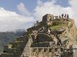 Tourists Climb The Intiwatana Pyramid, Machu Picchu, Peru by Dennis Kirkland Limited Edition Print