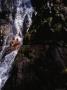 People Sliding Down Huai To Waterfall In Khao Phanom Bencha National Park, Krabi, Thailand by Bill Wassman Limited Edition Print