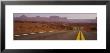 Highway Passing Through An Arid Landscape, Monument Valley Tribal Park, Arizona, Usa by Panoramic Images Limited Edition Pricing Art Print