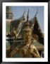 A Golden Buddha Statue Stands Outside The Grand Palace In Bangkok by Jodi Cobb Limited Edition Print