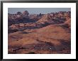 Mountain Bike Riders On Slickrock Trail Near Moab, Utah; Arches National Park Is In The Background by Joel Sartore Limited Edition Pricing Art Print