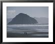 Two People Walk Along A Beach Near Morro Rock by Marc Moritsch Limited Edition Print