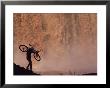 Silhouetted Cyclist Carrying Cycle Past Falls by Bill Hatcher Limited Edition Print