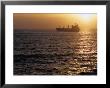 Cargo Ship At Sea Silhouetted At Sunset, Chile by Brent Winebrenner Limited Edition Print