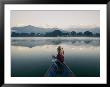 A Woman Stares At The Distant Annapurna Range From A Rowboat by Skip Brown Limited Edition Print