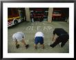 Fire Fighters Exercise And Stretch In Front Of Their Station by Joel Sartore Limited Edition Print