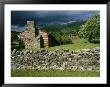 Storm Clouds Form Above Log Buildings On The Site Of French Azilum by Raymond Gehman Limited Edition Pricing Art Print