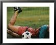 A Soccer Player Lands In The Mud In An Attempt To Field The Ball by Dugald Bremner Limited Edition Pricing Art Print