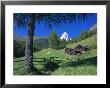 The Matterhorn Towering Above Green Pastures And Wooden Huts, Swiss Alps, Switzerland by Ruth Tomlinson Limited Edition Print