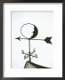 A Man-In-The-Moon Weather Vane On A Roof Top by Darlyne A. Murawski Limited Edition Print