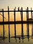 Young Woman Walking Across The Ubein Bridge In Mandalay, Burma At Sunset by Scott Stulberg Limited Edition Print