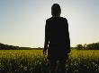 Silhouette Of A Woman In An Oilseed Rape (Brassica Napus) Field, Oraker, Upplands-Bro Municipality by Ewa Lundgren Limited Edition Print