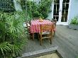 Small Town Garden With Decking, Paving, Table And Chairs, Trachycarpus Fortunei And Hammock by Clive Nichols Limited Edition Pricing Art Print