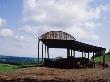 Semi-Derelict Corrugated Iron Barn Silhouetted Against View Of Countryside, Rusting, Somerset by Philippa Lewis Limited Edition Print