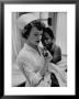 Nurse Holding African American Girl In Her Arms, Examining Her Finger by John Dominis Limited Edition Pricing Art Print