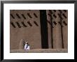 Man Sitting At Base Of Mud-Brick Wall Of The Grand Mosque, Djenne, Mopti, Mali by Jane Sweeney Limited Edition Pricing Art Print