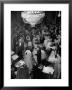 Young Couples At Formal Dance Dreamily Swaying On Crowded Floor Of Dim, Chandelier-Lit Ballroom by Nina Leen Limited Edition Print