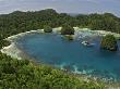 Live-Aboard Dive Vessel At Anchor In The Raja Ampat Islands, Indonesia by David B. Fleetham Limited Edition Print