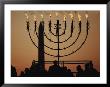 Silhouetted Worshippers Stand Before A Large Menorah Near The Washington Monument by Sam Kittner Limited Edition Print