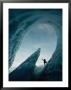 A Climber Raises His Ax In Triumph Near The Opening Of An Ice Cave by George F. Mobley Limited Edition Print