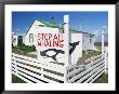 An Anti-Whaling Sign In Front Of Falkland Traditional Wooden House, Falkland Islands by Marco Simoni Limited Edition Print