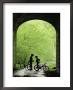 Two Silhouetted Cyclists Stop In A Tunnel On A Bike Trail by Richard Nowitz Limited Edition Print