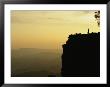 A Climber Stands Silhouetted On A Cliff In South Africa by Bill Hatcher Limited Edition Print