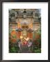 Balinese Dancer Wearing Traditional Garb Near Palace Doors In Ubud, Bali, Indonesia by Jim Zuckerman Limited Edition Print