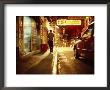 Man And A Taxi On A Shop-Lined Hong Kong Street At Night by Eightfish Limited Edition Print