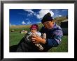 Boy And Baby In Front Of Yurt Camp, Kyrgyzstan by Anthony Plummer Limited Edition Print