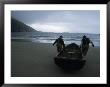 Commercial Salmon Fishermen Carry Their Boat Out To Check Their Nets by Paul Nicklen Limited Edition Print