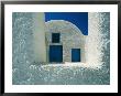 View Of The White Walls And Blue Doors Of One Of Theras Cliff-Top Houses by Todd Gipstein Limited Edition Print
