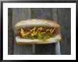A Hot Dog Is Covered In Condiments Like Mustard, Ketchup And Relish by Stephen Alvarez Limited Edition Pricing Art Print