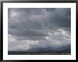 Rain Squalls Hover Over Panamint Range With Sun Over The Salt Pan by Gordon Wiltsie Limited Edition Print