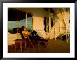 Woman Sitting On A Deck Chair Of A Cruise Ship Watching The Sunset by Todd Gipstein Limited Edition Print