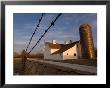 A Barbed Wire Fence Frames The Barn At Historical Steven's Creek Farm by Joel Sartore Limited Edition Pricing Art Print