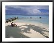 Woman Reads In Solitude On A Quiet Beach Next To Turquoise Water by James L. Stanfield Limited Edition Print