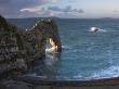 Archway Of Durdle Door Glowing Golden In Early Morning Sunlight, Jurassic Coast, Dorset, England by Adam Burton Limited Edition Pricing Art Print